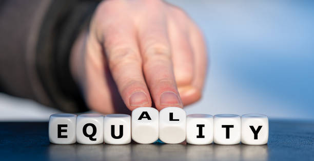Dice forms the words equity and equality. Dice forms the words equity and equality. equity vs equality stock pictures, royalty-free photos & images