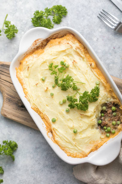 istock Shepherd's Pie with ground beef, potato and cheese on wooden background, top view, copy space. Traditional homemade Irish casserole 1300471583