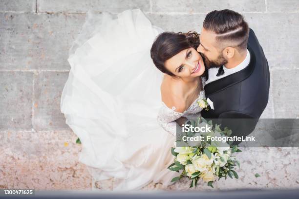 Beautiful Wedding Couple Cuddling On Their Wedding Day Stock Photo - Download Image Now
