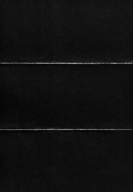 istock Old Black Empty Ripped Folded Torn Cardboard Paper Poster. Grunge Scratched Old Shabby Surface. Distressed Overlay Texture for Collage. 1300471899