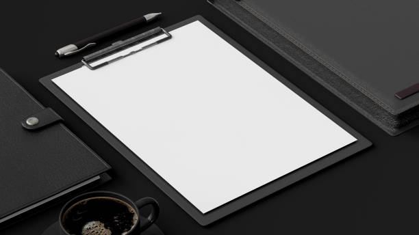 istock Clipboard on black office desk. 1300472625