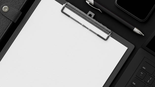 istock Clipboard on black office desk with notebook and cup coffee. 1300472630