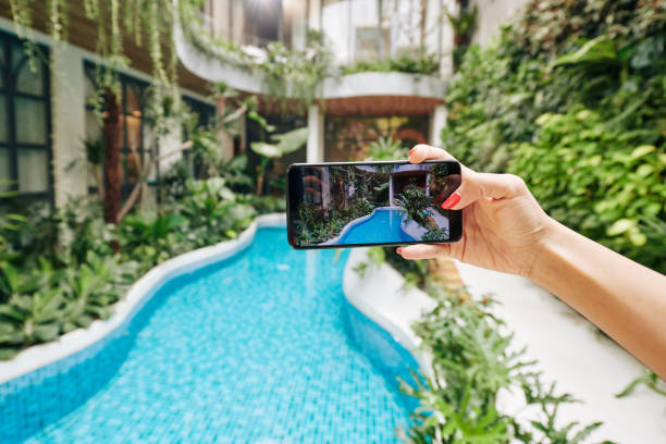 istock Woman photographing swimming pool 1300472944