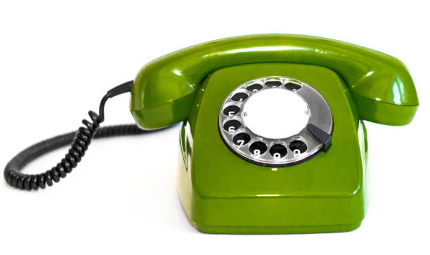 istock Old green rotary telephone on a white background 1300473220