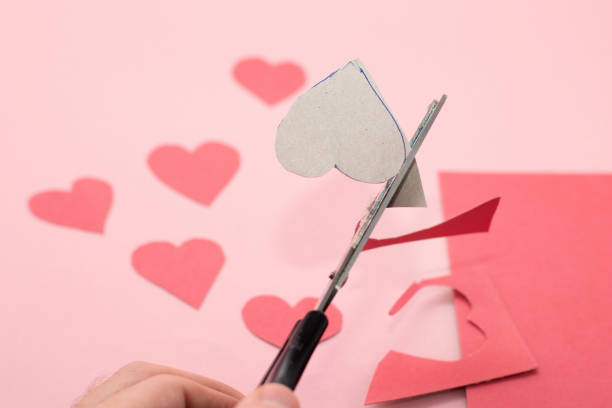 istock Hands making red Valentine card from paper. Step by step instructions DIY. 1300473351