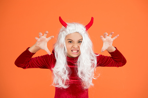 celebrate the holidays. childhood. happy halloween devil girl. teenage child in imp horns. angry kid has white hair. spooky and creepy. carnival costume party. trick or treat.