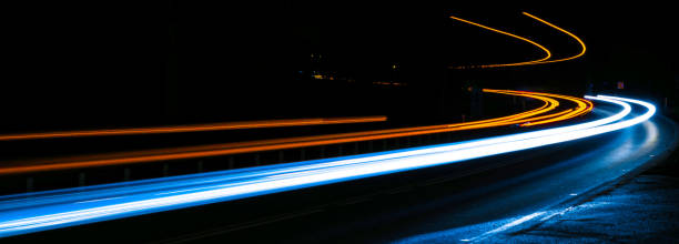 istock orange and blue car lights at night 1300474711