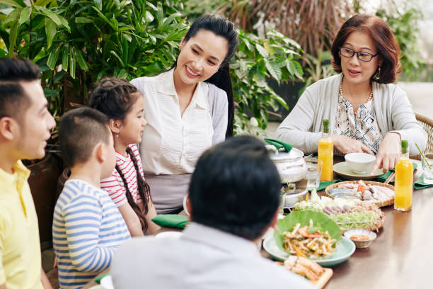 istock Asian family enjoying dinner 1300475521