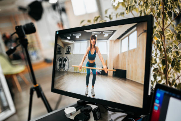 istock Camera is recording female athlete doing exercises 1300475648