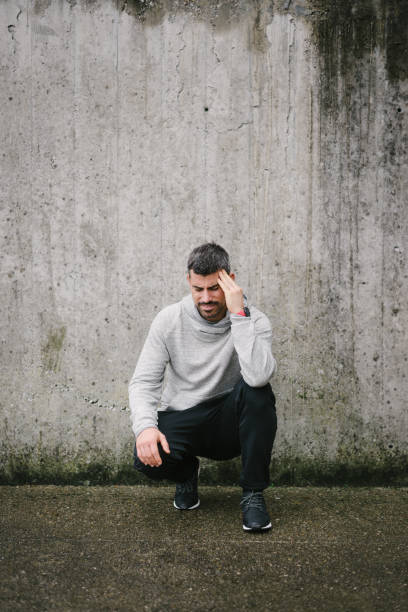 istock Sick sportsman suffering headache 1300475669