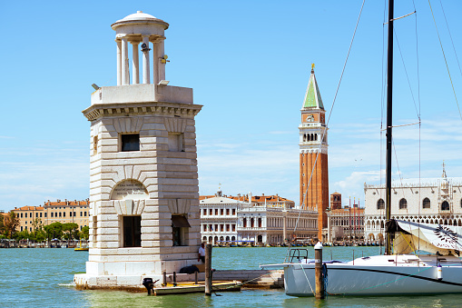 View of Ponta della Dogana from the Giudecca Canal at Venice, Italy. The building Dogana da Mar in Dorsoduro was built in the 15th century for customs and docking porposes and is now an art museum. It is right in the point where Grand Canal and Giudecca Canal meet and in front of the main island of Venice and it can be seen from the main island through the Grand Canal.