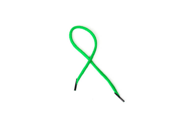 istock One green shoelace isolated on white 1300477072