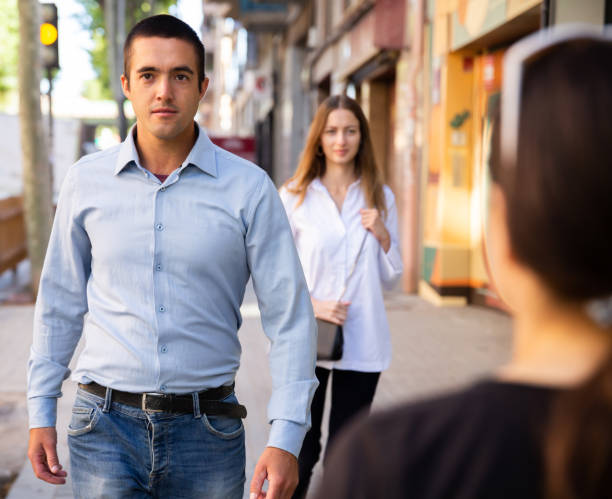 istock Young people walking on summer city streets 1300478038