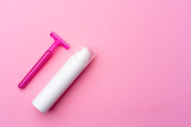 istock Shaving gel and disposable shaver on pink background top view 1300478111