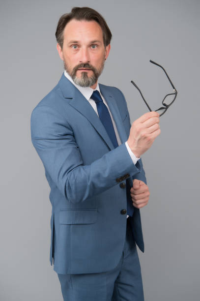 istock Teacher lecturer speaker. Intelligent concept. Hard to answer. Difficult question. Serious businessman. Education for adults. Perplexedly removes glasses. Business education. Self education 1300478639