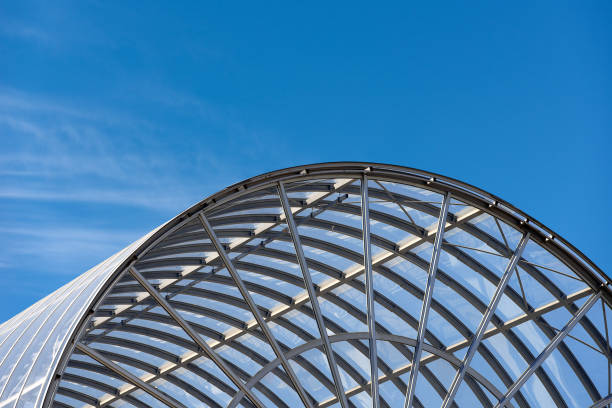 istock Modern Glass and Steel Architecture on Blue Sky with Clouds 1300479750