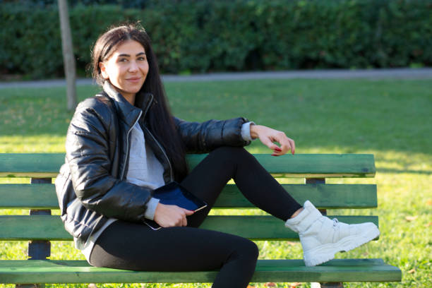 istock Beautiful woman having fun at park 1300479754