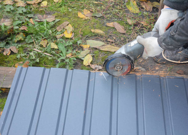 istock Constructing a roof a building contractor is cutting, making shorter a metal corrugated roof tile or fence panel using an electric angle grinder, a power disc grinder. 1300481390