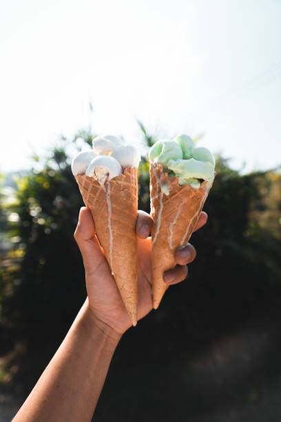 istock Ice cream cone,Ice cream in hand during the hot day 1300482727