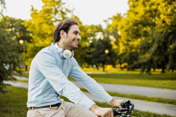 istock Young businessman uses a bicycle as a mode of transportation to work 1300483003