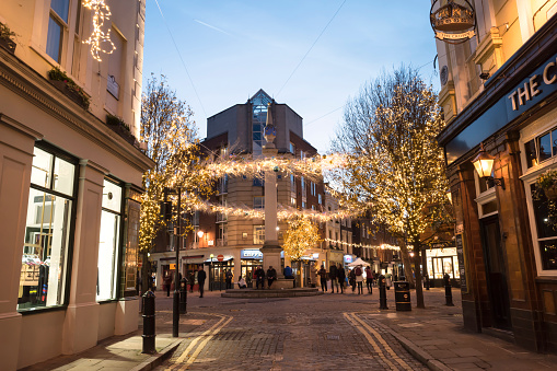 London, UK - December 17, 2020: Street view at Seven Dials in the St Giles district of the London Borough of Camden in London West End with Christmas lights during the holidays