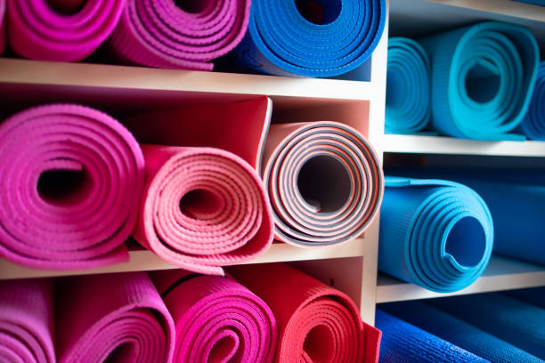 istock Pink and blue exercise mats on shelves in repository 1300484471