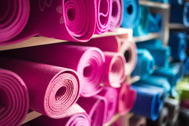 istock Pink and blue exercise mats on shelves in gym repository 1300484511