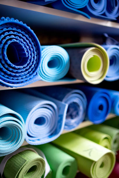istock Blue and green exercise mats on shelves in gym repository 1300484517