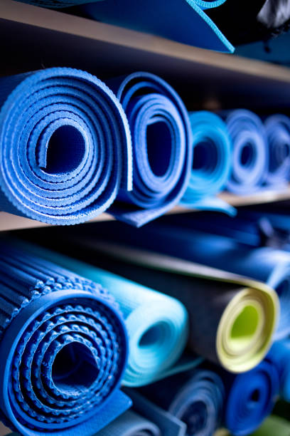 istock Blue exercise mats on shelves in gym repository 1300484577