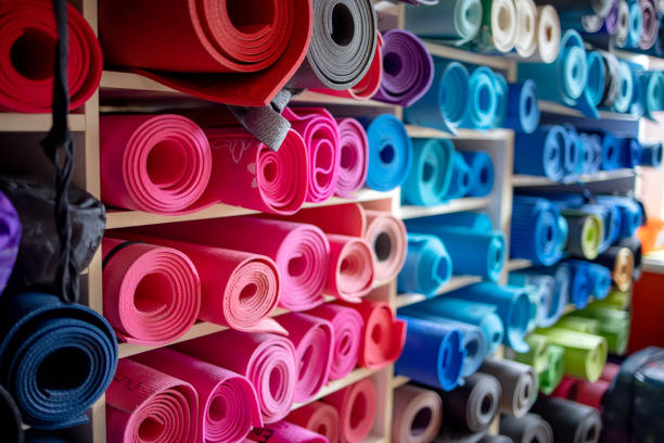 istock Pink, blue and otherwise colored exercise mats on shelves in repository 1300484805