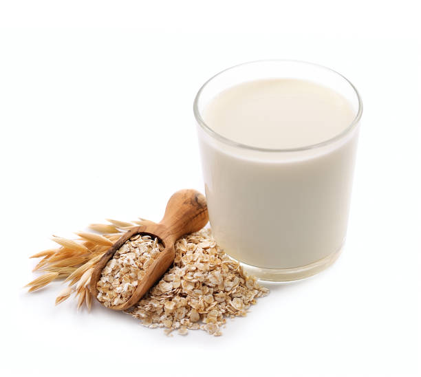 Glass of vegan oat milk on white backgrounds. stock photo