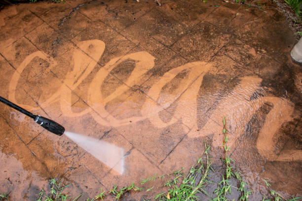 Cleaning backyard paving tiles with pressure washer. Cleaning backyard paving tiles with pressure washer. Spring clean up hanging stone stock pictures, royalty-free photos & images