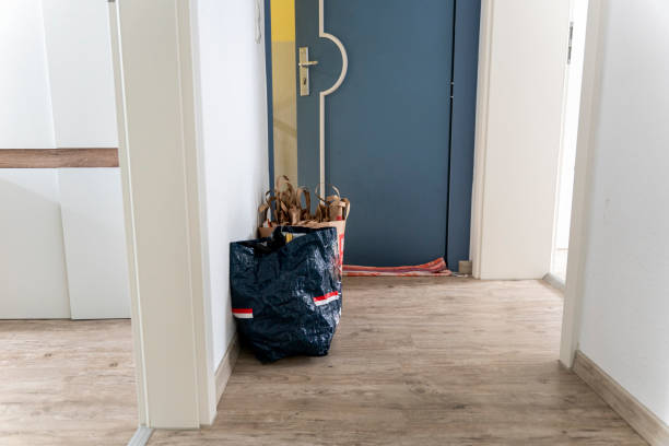 Two trash bags in the hallway close to front door stock photo