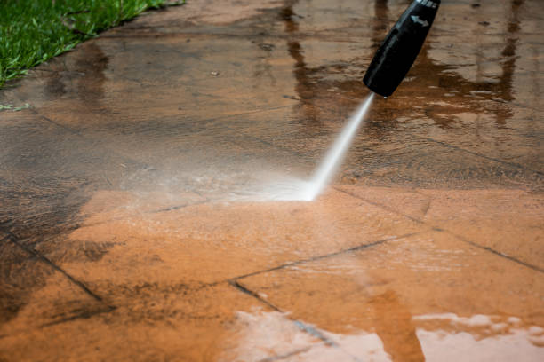 Cleaning backyard paving tiles with pressure washer. Cleaning backyard paving tiles with pressure washer. Spring clean up hanging stone stock pictures, royalty-free photos & images
