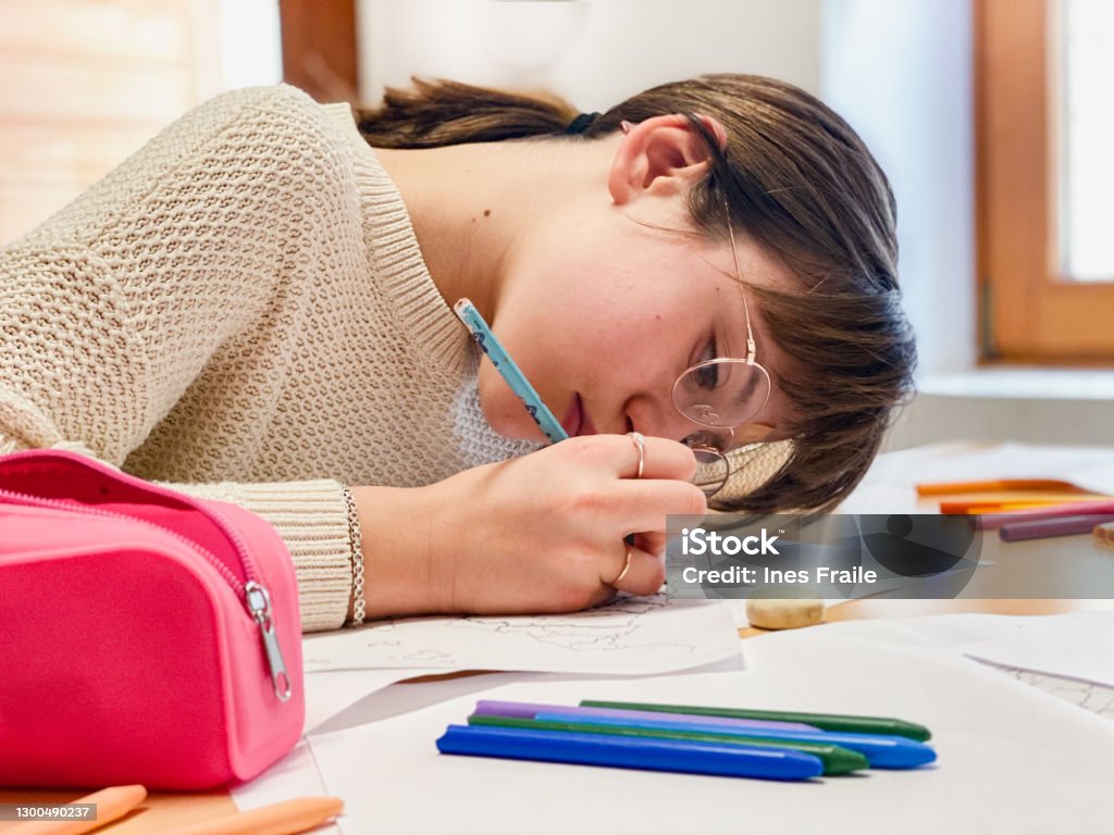 Homeschooling Girl studying at home Myopia Stock Photo