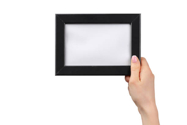 istock Female hands holding photo frame isolated on white 1300490384
