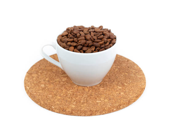 A cup of coffee beans isolated on a white background.