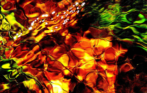 istock Jewelled effect of slow moving stream over river bed. Abstract art 1300497152