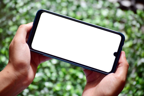 istock Both hand holding blank screen smartphone, mobile phone gaming gesture 1300498806