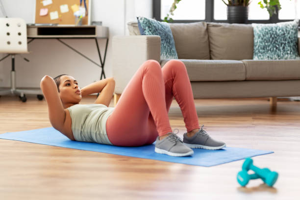 istock african woman making abdominal exercises at home 1300504499