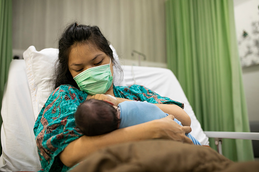 asian Mother feeding her newborn baby in the hospital