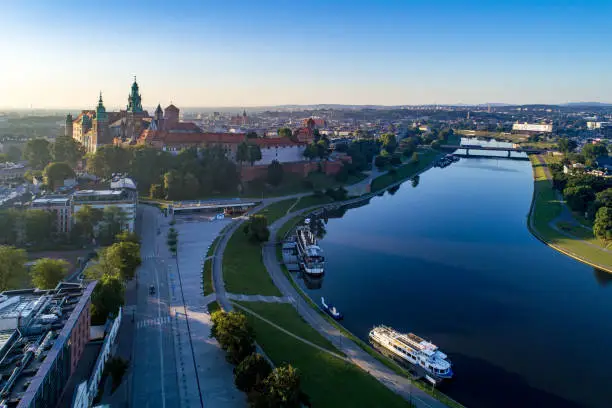 Krakow, Poland. Aerial panorama in sunrise light with Wawel Cathedral, Vistula River, harbor and tourist ship