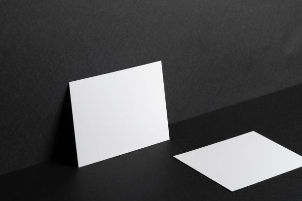 istock White businesscards on black background close up 1300507427