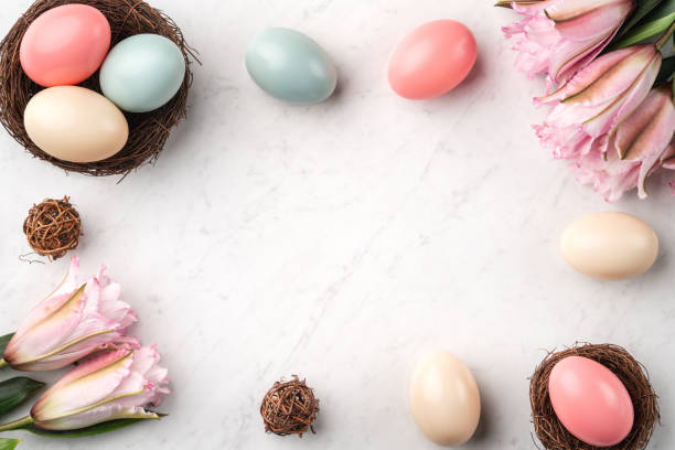 Colorful Easter eggs in the nest with pink Double Lily flower. Colorful Easter eggs in the nest with pink lily flower on bright marble white table background. double flower stock pictures, royalty-free photos & images