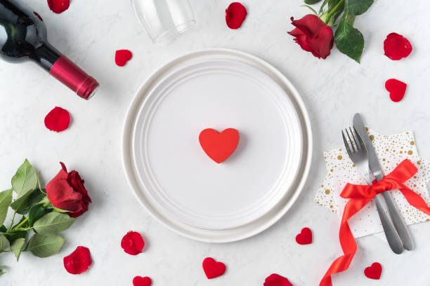 istock Plate with red rose for Valentine's Day dating meal concept. 1300508049