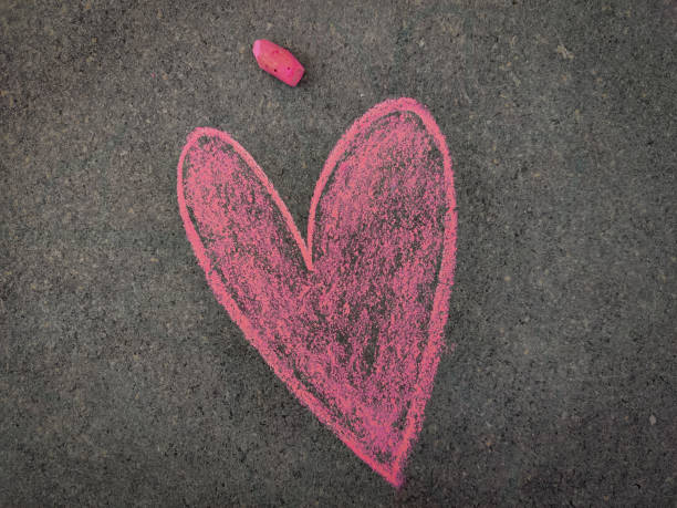 istock Hand drawn heart or love symbol. Valentines day concept. Using color chalk pieces. 1300508778