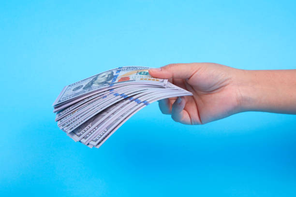 istock HAND HOLDİNG American Dollar banknotes 1300508904
