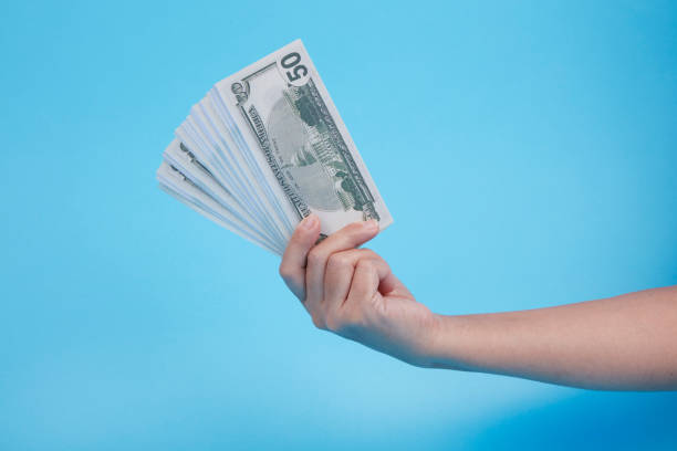 istock HAND HOLDİNG American Dollar banknotes 1300509027