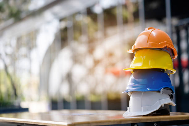 Group Safety Construction Worker Hats. Teamwork of the construction team must have quality. Whether it is engineering, construction workers. Have a helmet to wear at work. For safety at work. stock photo