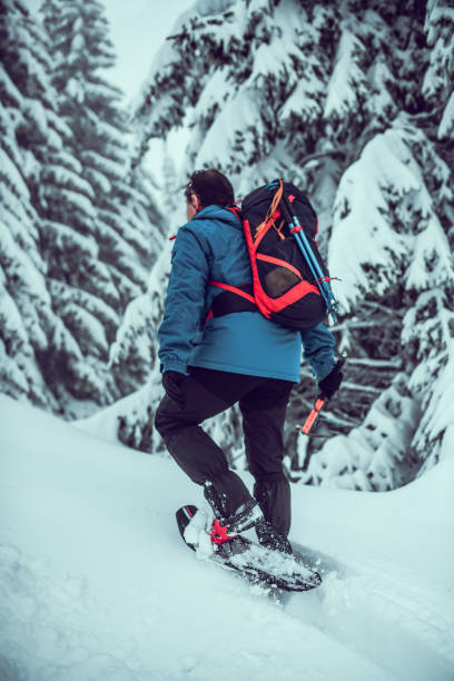 istock Senior Alpinist Walking Through Mountain Snow With Ease 1300509308